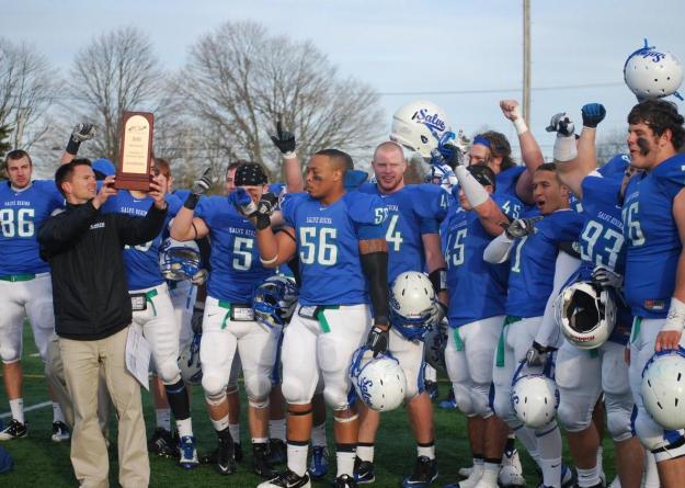 Seahawk head coach Bob Chesney holds trophy aloft after Salve Regina captured the 2011 ECAC North-West Championship Bowl (11/19/11). The Seahawks are leading the charge for a registration drive for bone marrow donors on campus on Wed., April 18.