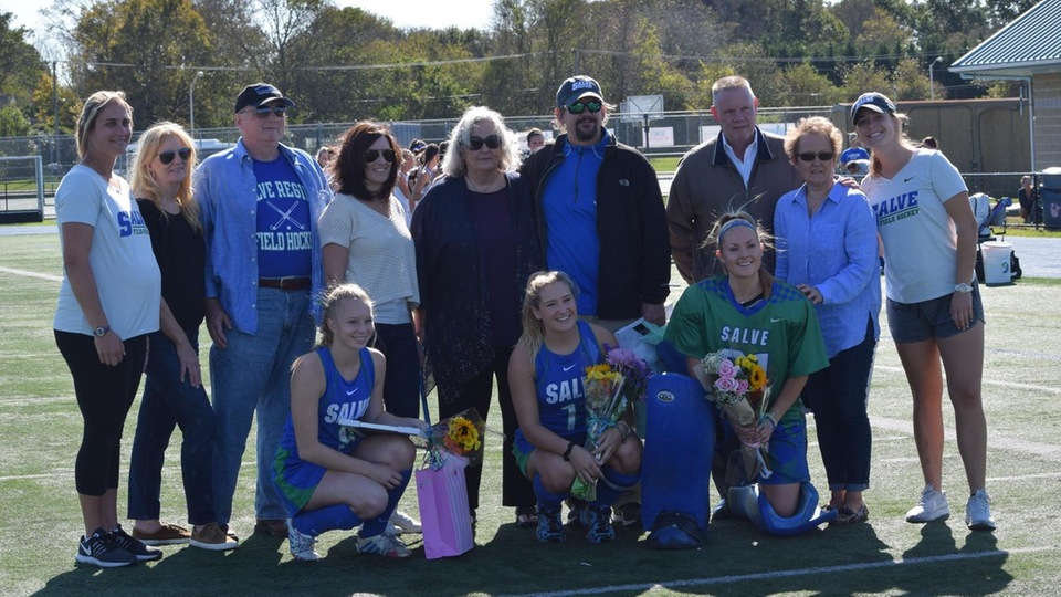 Seahawk field hockey seniors - Brooke Tolley, Amber Cody, Jessie Severino - take a knee in front of family and coaches. (Photo by Jordin Bonarcorsi)