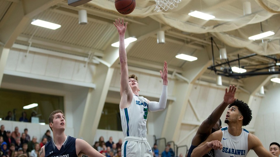 Kevin Kelly (#3 in middle) scores two of his team-high 25 points as Salve Regina swept its season series with Gordon. (Photo by Rob McGuinness)