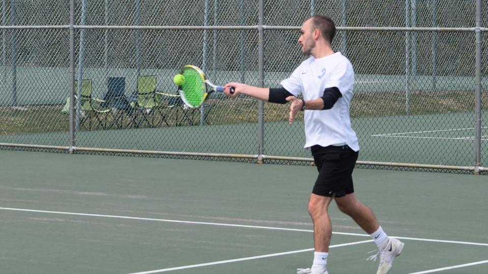 D.J. Bisaillon returns a serve with his forehand at No. 2 doubles action paired with Matthew Newfield. (Photo by Tyler Benjamin)