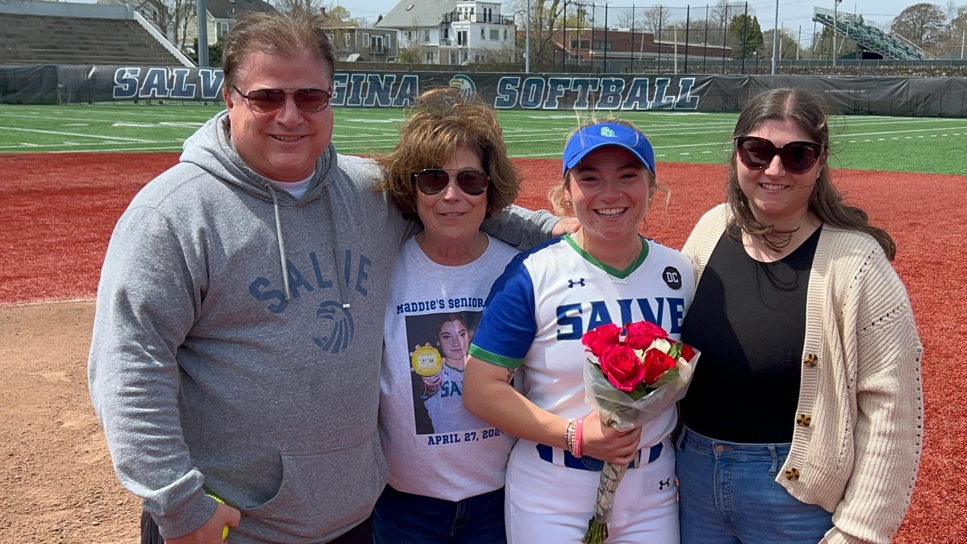 Seahawk senior Maddie Capetta is joined on the diamond by her family (father-Michael, mother-Marisa, sister-Maria) during pre-game ceremonies. (Photo by Ed Habershaw '03M)