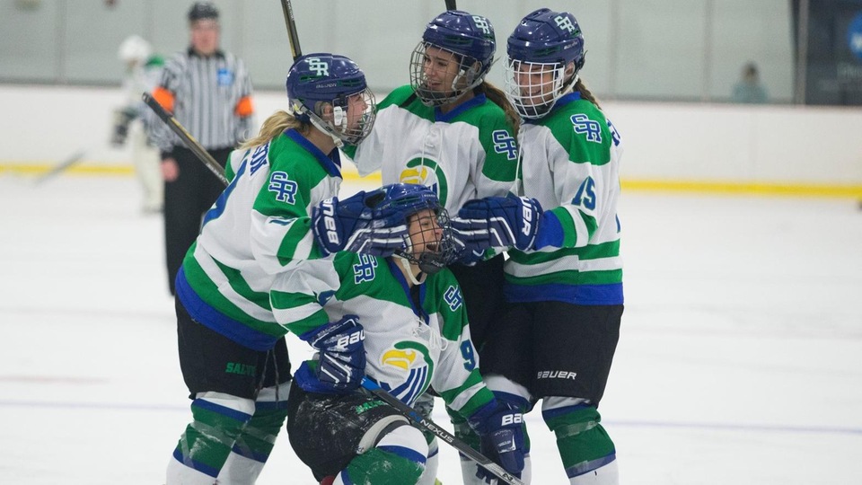 Maddy McCann celebrates with teammates after scoring on an empty net to seal a victory for Salve Regina (Photo by Rob McGuinness).