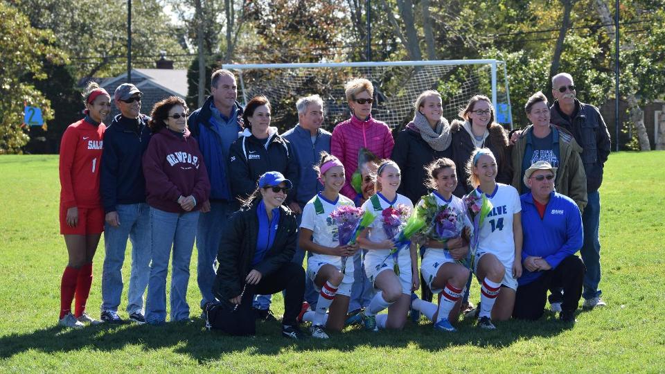 Seahawk seniors (front row) - Christine Pala, Lindsey Sasso, Erica Manchester, Raine Oesterle - surrounded by family and coaches. (Photo by Alex Perry)