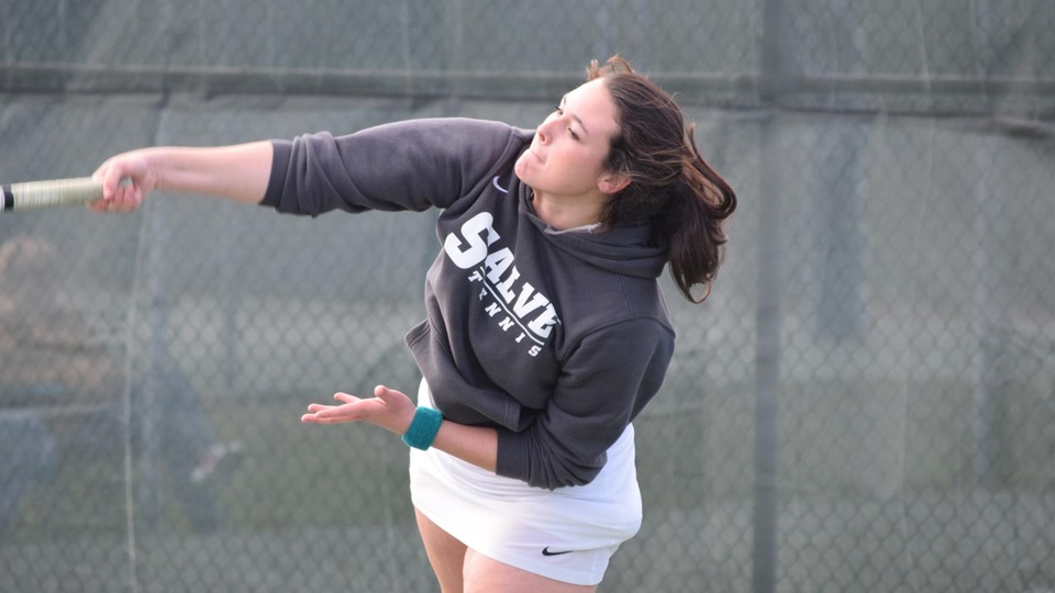 Laura Krick with a serve early in her doubles match on Friday. (Photo by Ed Habershaw)