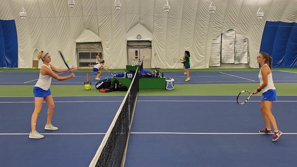 Annemarie Haas (left) and Lily Gorman warming up before playing doubles against Wentworth at Mt. Auburn Tennis Club in Watertown, Mass. (Photo by Adam Zaccara)