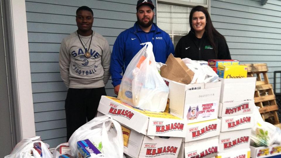 Derrick Sarfo-Darko, Matthew Keyser, and Molly O'Sullivan represented Salve Regina's student-athletes and members of SAAC in delivering the donated food to the Martin Luther King Center.