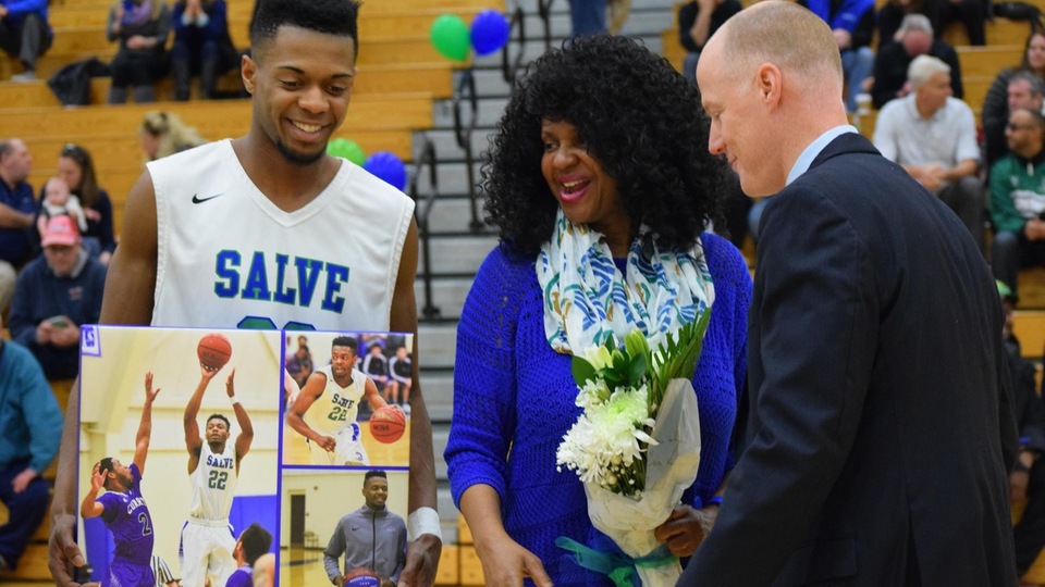 Senior Rodney Morton joined by his mother and head coach Sean Foster before final regular season home game. (Photo by Hannah Filiault)