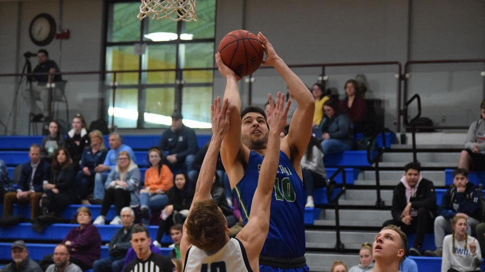 Mikey Spencer rises up for two in the first half at Roger Williams on Wednesday evening. (Photo by Ed Habershaw)
