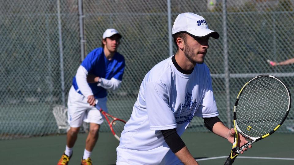 Jack Lawlor (background) completes a serve while freshman partner D.J. Bisaillon anticipates a poach. (Photo by Ed Habershaw)