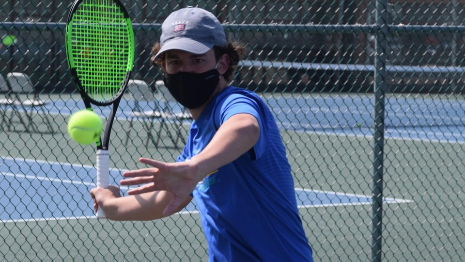 Freshman Ned Batstone eyes a forehand during his match on April 10 against Roger Williams. (Photo by Ed Habershaw)