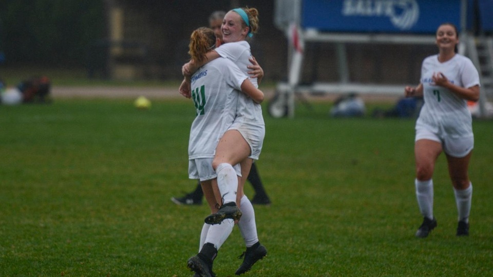 Olivia Pickard (14) and Carah Cote celebrate Salve Regina's third goal in the first 17 minutes; Emily Smith (7) runs to join her teammates. (Photo by George Corrigan)