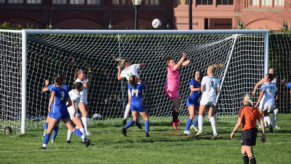 Reagan Moffatt (GK) punches ball away from goal area in second half action versus Worcester State; Seahawks won, 3-2. (Photo by Ed Habershaw '03M)