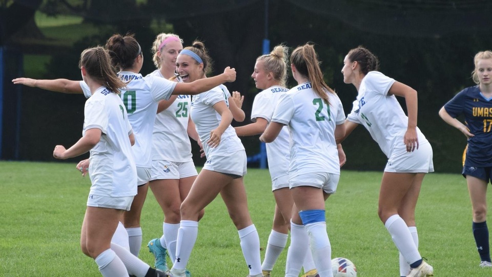 Taylor Barnaby (fourth from left) celebrates her first collegiate goal with fellow Seahawks. (Photo by Andrew Pezzelli)