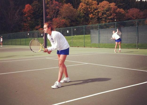 Elizabeth DiFilippo '15 serving with Ana Gwozdz '14 at net during competition at the New England Women's Invitational Tennis Tournament at Smith College on Saturday (photo by Erica Shay '15).