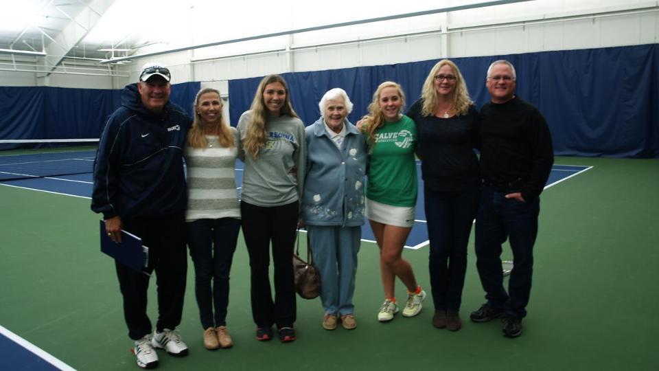Seniors Kasey Walther and Julie Grant posing with their families and head coach Cory Tusler. (Photo by Ed Habershaw)