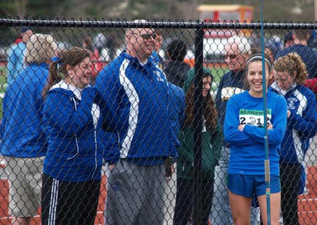 Victoria Beardwood (left), Coach Richard Ratcliff (center), and Rebecca Longvall share a laugh before Longvall won the javelin throw.
