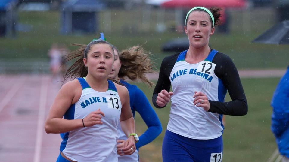 Victoria Varone (left) and Shannon Holden did not mind the rain as they ran to qualify for the NCAA Division III New England Championships in the 10,000-meter race. (Photo by Jen McGuinness)