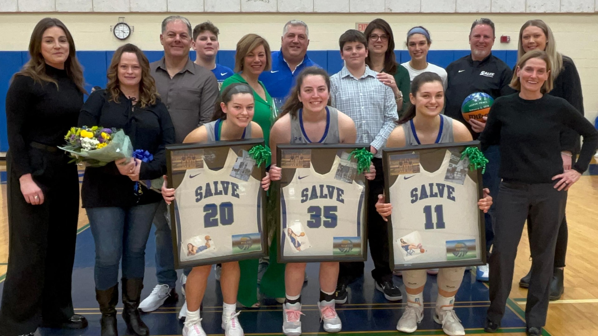 Seahawk seniors - Amanda Folan (#20), Olivia Martin (#35), Briana Neary (#11) - joined by their families and coaches before final regular season home game at the Rodgers Recreation Center. (Photo by Ed Habershaw '03M)