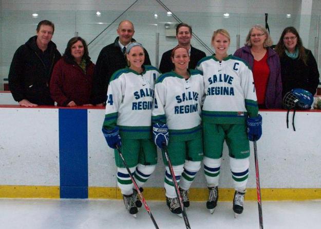 Shannon Coleman, Natalia Madryga, and Monika Borkowski stand on ice in front of family and head coach Michael Cox.